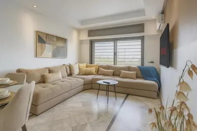a living room with a couch and a table at Cosy and sunny - private Rooftop - near train & tramway in Casablanca