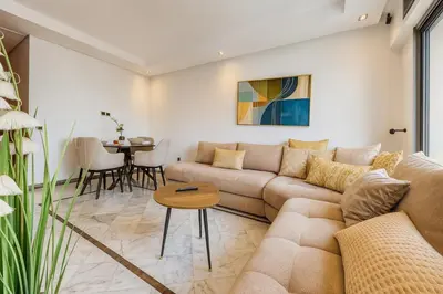 a living room with a couch and a table at Cosy and sunny - private Rooftop - near train & tramway in Casablanca