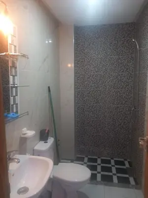 a bathroom with a toilet and a sink and a shower at appartement bouznika in Bouznika