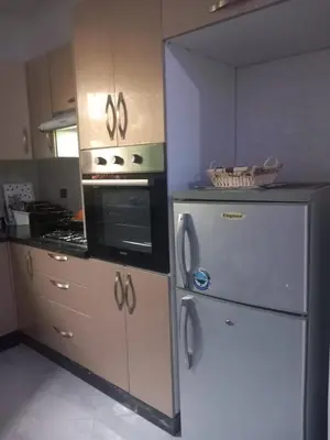 a kitchen with a refrigerator and a stove at appartement bouznika in Bouznika