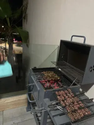 a grill with many different types of food on it at Rock Island Appartement Haut standing pied dans l'eau Mohammedia in Mohammedia