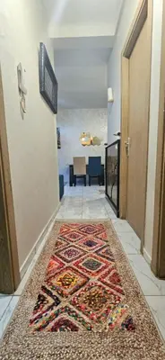 a hallway with a rug on the floor at Quiet and Cozy Apartment in Casablanca