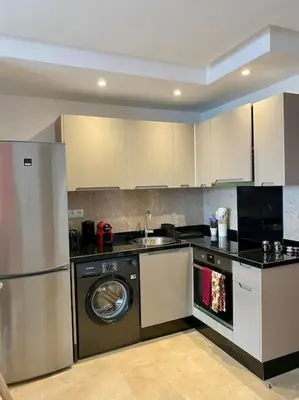 a kitchen with a washer and a dishwasher at Zafiro - L'appartement de vos rêves - Casablanca in Casablanca