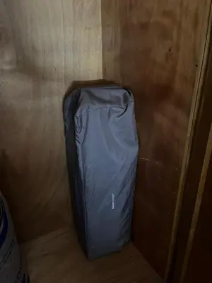 a blue suitcase sitting in a corner of a room at Family Appartement Nouaceur Aéroport Med V in Nouaceur
