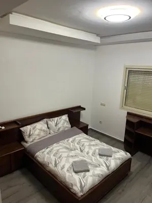 a bedroom with a bed in a room with a window at Family Appartement Nouaceur Aéroport Med V in Nouaceur
