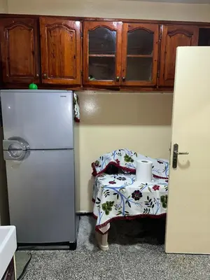 a kitchen with a small table and a refrigerator at Chambre cosy au cœur de Rabat in Rabat