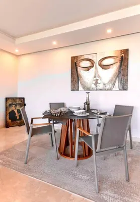 a dining room with a table and chairs at Appartment De Lux a California in Bali Luxury Residence in Casablanca