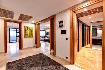 a hallway with a door open to a living room at Appartment De Lux a California in Bali Luxury Residence in Casablanca