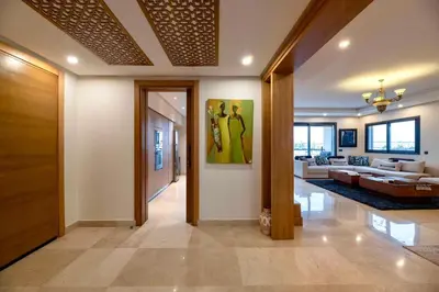 a hallway with a living room with a couch at Appartment De Lux a California in Bali Luxury Residence in Casablanca