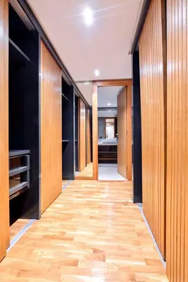 a hallway with wood paneling and a room with a kitchen at Appartment De Lux a California in Bali Luxury Residence in Casablanca