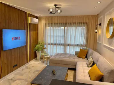 a living room with a couch and a tv at C39 1BR Studio - Cozy & Central in Maarif in Casablanca