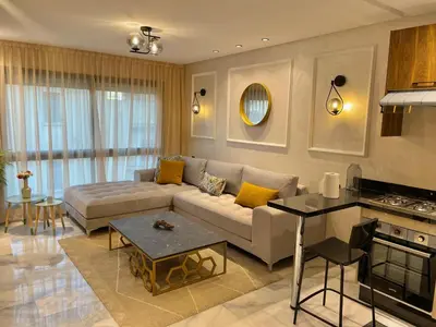 a living room with a couch and a table at C39 1BR Studio - Cozy & Central in Maarif in Casablanca