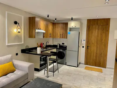 a kitchen with a couch and a table in a room at C39 1BR Studio - Cozy & Central in Maarif in Casablanca