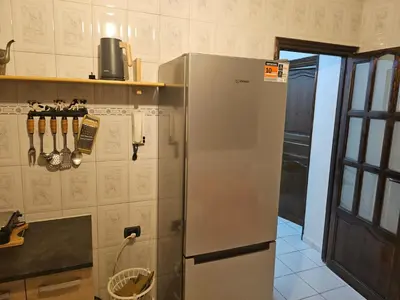 a kitchen with a stainless steel refrigerator at Appartement ensoleillé de 100 m2 à Mohammedia à 10 mn de la mer in Mohammedia