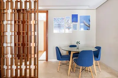 a dining room with a table and blue chairs at TT holidays Casa Oasis in Casablanca