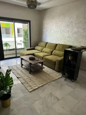 a living room with a couch and a coffee table at Résidence Natura Living au parc in Mohammedia