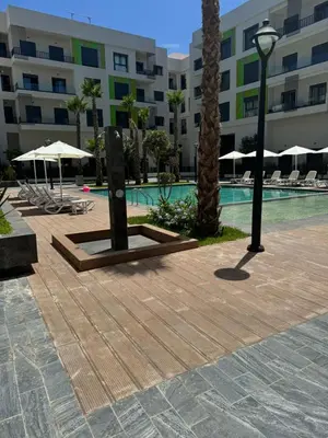 a resort with a swimming pool and a hotel at Résidence Natura Living au parc in Mohammedia