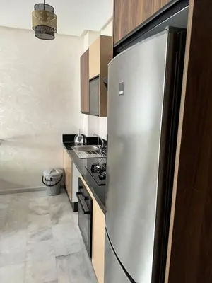 a kitchen with a stainless steel refrigerator at Résidence Natura Living au parc in Mohammedia