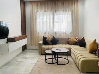 a living room with a couch and a table at Studio cosy in Nouaceur