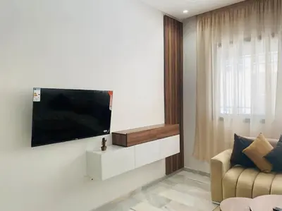 a living room with a flat screen tv on a wall at Studio cosy in Nouaceur