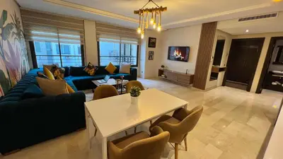 a living room with a blue couch and a table at D2 L'Art de Vivre Urbain au Cœur de Casablanca maarif in Casablanca