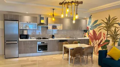a kitchen and dining room with a table and chairs at D2 L'Art de Vivre Urbain au Cœur de Casablanca maarif in Casablanca