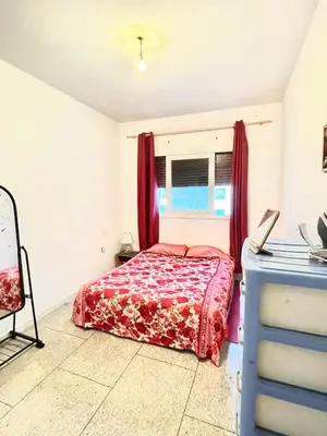 a bedroom with a bed and a window at Chambre Privée en plein centre de Rabat Agdal in Rabat