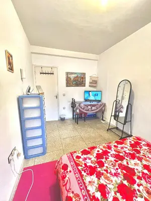 a bedroom with a bed and a dresser and a desk at Chambre Privée en plein centre de Rabat Agdal in Rabat