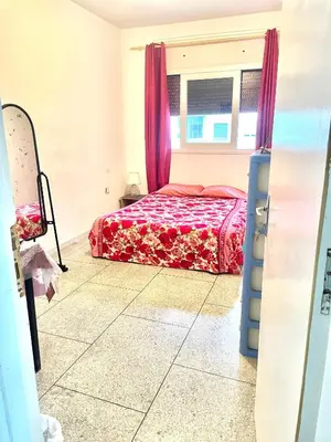 a bedroom with a bed and a window at Chambre Privée en plein centre de Rabat Agdal in Rabat