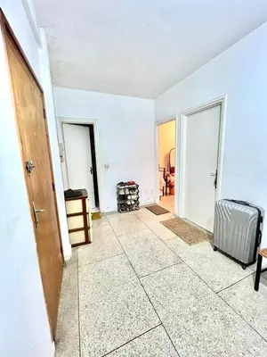an empty living room with white walls and a door at Chambre Privée en plein centre de Rabat Agdal in Rabat