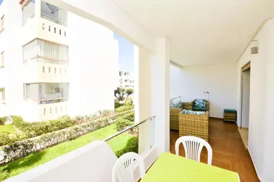an apartment balcony with a table and chairs at Modern Marina - Beach - Pool in Sidi Rahal