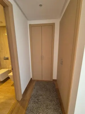 a hallway with a closet and a door with a rug at My Cosy Place - Apartment 2BR - Piscine -Résidence Marbella Hay Riad in Rabat