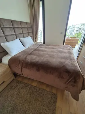 a large bed in a room with a large window at My Cosy Place - Apartment 2BR - Piscine -Résidence Marbella Hay Riad in Rabat
