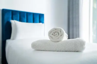 a white towel sitting on top of a bed at Résidence Luxe avec Plage Privée in Bouznika