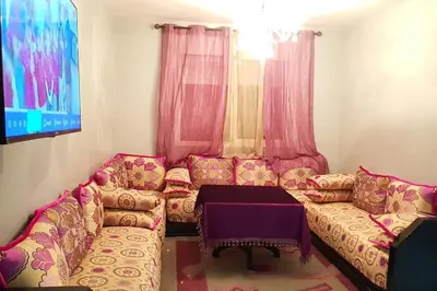 a living room with a couch and a table at Appartement entier Familial Tamaris-Dar Bouazza-Casablanca in Dar Bouazza