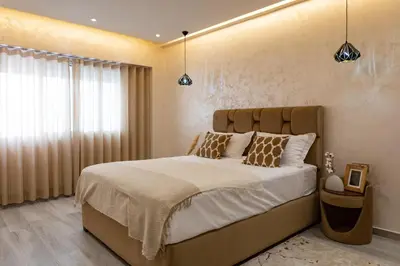a bedroom with a large bed and a window at Joli appartement 2 chambres in Casablanca