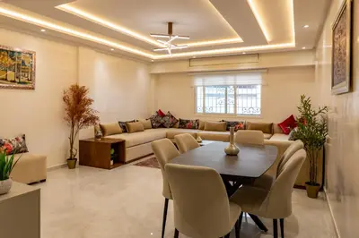 a living room with a table and a couch at Joli appartement 2 chambres in Casablanca