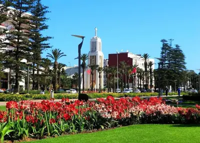 a park with flowers in front of a building at Studio a Mohammedia pied dans l'eau in Mohammedia