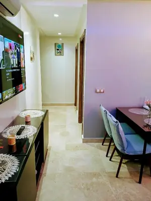 a living room with a table and a chair at Beachside Apartment in Mohammedia