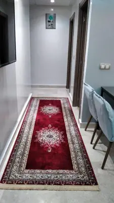 a red rug on the floor in a room at Beachside Apartment in Mohammedia