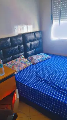 a blue bed in a room next to a desk at chic chambre meublée in Casablanca