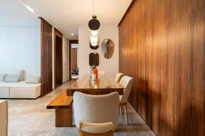 a dining room with a wooden table and chairs at Élégance Urbaine Casa Finance city in LʼOasis
