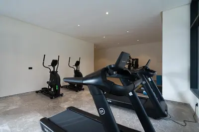 a gym with three exercise bikes in a room at Élégance Urbaine Casa Finance city in LʼOasis