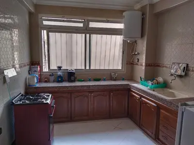 a kitchen with a stove and a sink and a window at Happy House in Océan