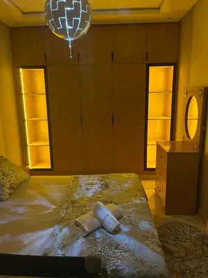 a bedroom with a bed with two pillows on it at Résidence kettani piscine bouznika in Bouznika