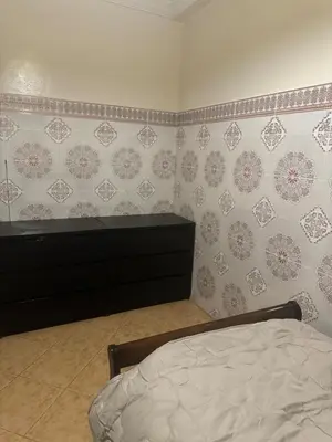 a bedroom with a bed and a dresser at Sahara beach Mansouria in Mansouria