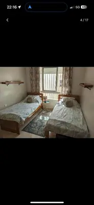 two beds in a room with a window at Bouznika, Shems Kettani in Bouznika