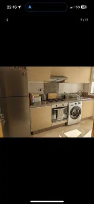 a kitchen with a refrigerator and a washing machine at Bouznika, Shems Kettani in Bouznika