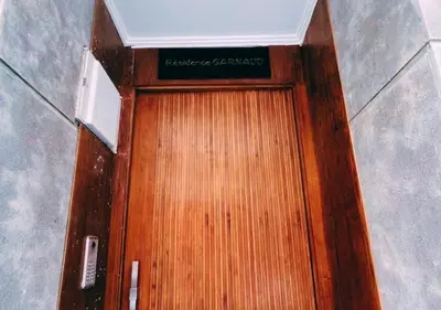 a wooden door with a sign on top of it at Chic Urban Studio - Maarif Casablanca - Walk to Twin Center in Casablanca