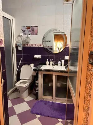 a bathroom with a sink and a mirror at Maison wafaa in O Ben Slimane